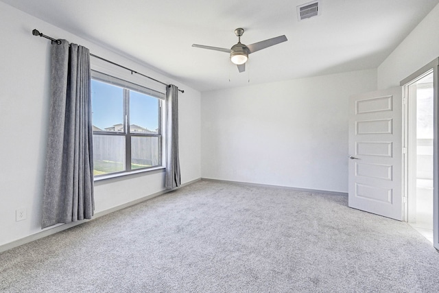 carpeted spare room featuring ceiling fan