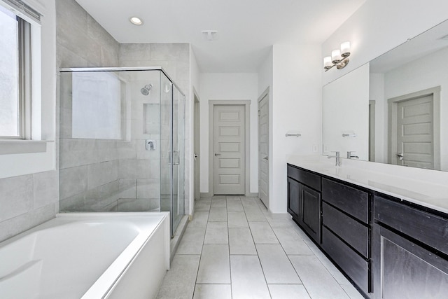 bathroom featuring vanity, tile patterned floors, and plus walk in shower