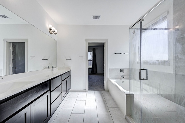 bathroom featuring tile patterned floors, independent shower and bath, and vanity