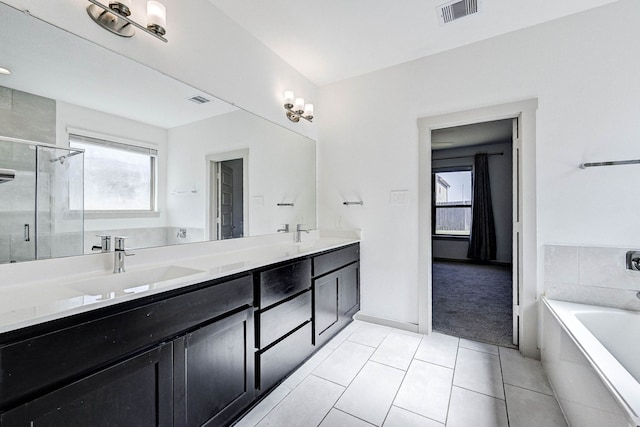 bathroom featuring independent shower and bath, vanity, and tile patterned floors