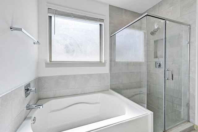 bathroom with separate shower and tub