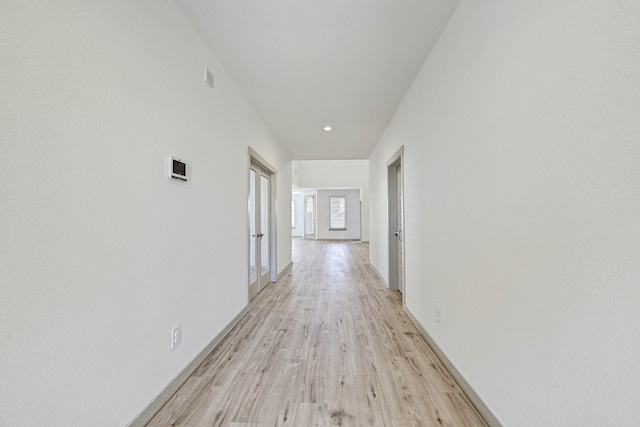 hallway with light hardwood / wood-style flooring