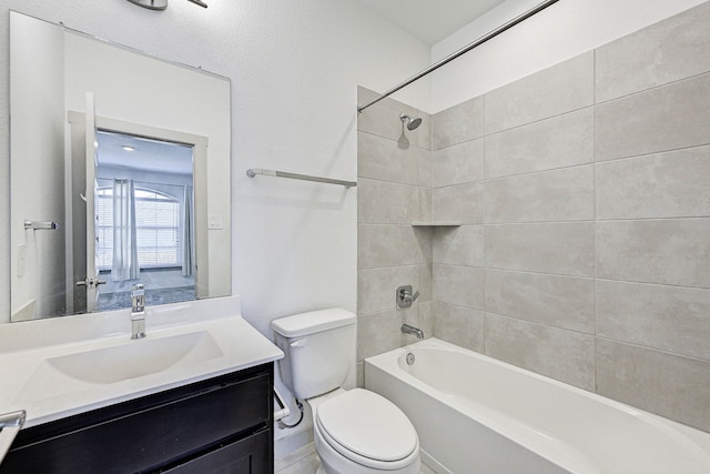 full bathroom featuring vanity, toilet, and tiled shower / bath combo