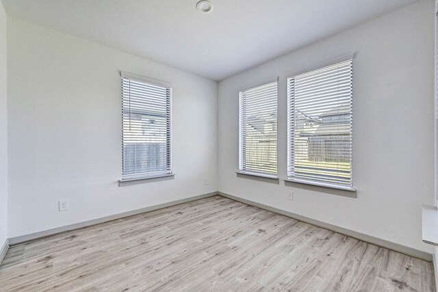 unfurnished room with light hardwood / wood-style flooring