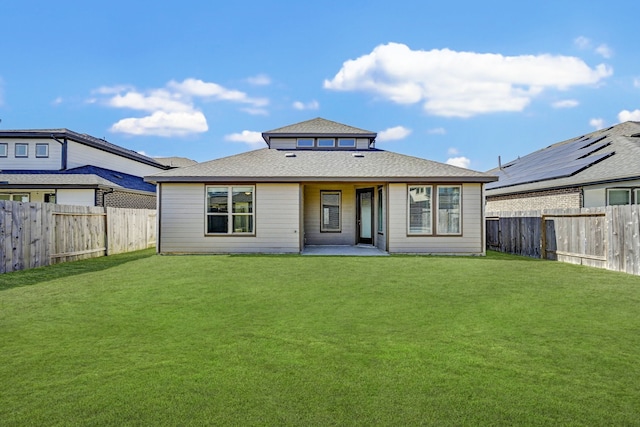 back of house featuring a patio and a lawn