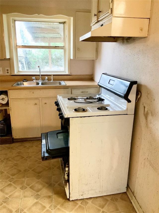 kitchen with sink and white gas range oven