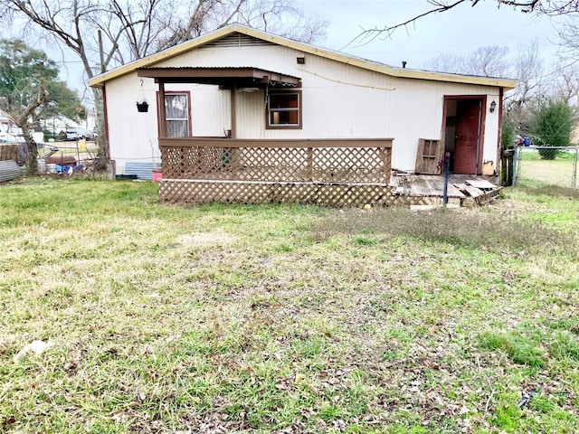 rear view of property with a yard