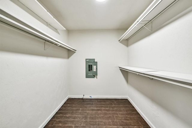 walk in closet featuring dark wood-type flooring and electric panel