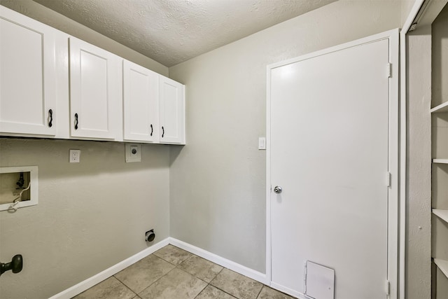 washroom featuring cabinets, a textured ceiling, light tile patterned floors, hookup for a washing machine, and hookup for an electric dryer