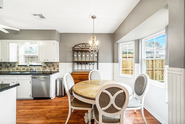 dining space featuring sink, a healthy amount of sunlight, and light wood-type flooring