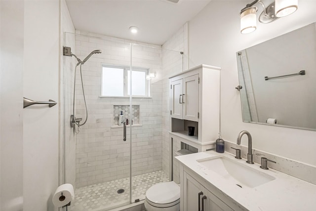 bathroom with vanity, toilet, and walk in shower