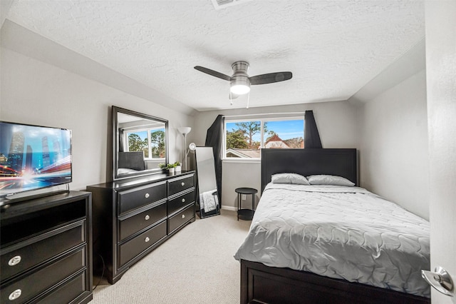 carpeted bedroom with a textured ceiling and ceiling fan