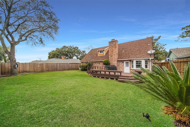 back of house with a wooden deck and a yard