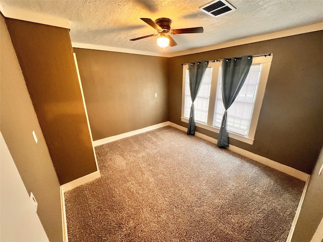 carpeted empty room featuring ceiling fan and a textured ceiling