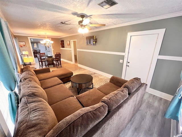 living room with hardwood / wood-style floors, crown molding, and a textured ceiling