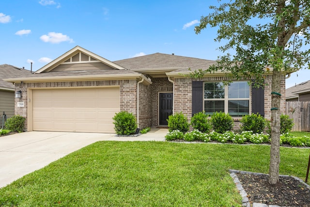 view of front of home featuring a garage and a front yard