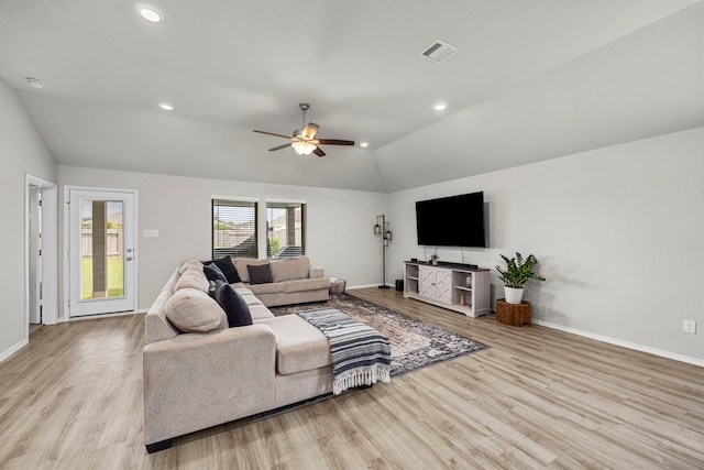 living room with ceiling fan, lofted ceiling, and light hardwood / wood-style floors