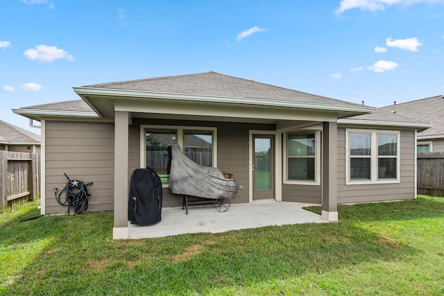 back of house featuring a yard and a patio area