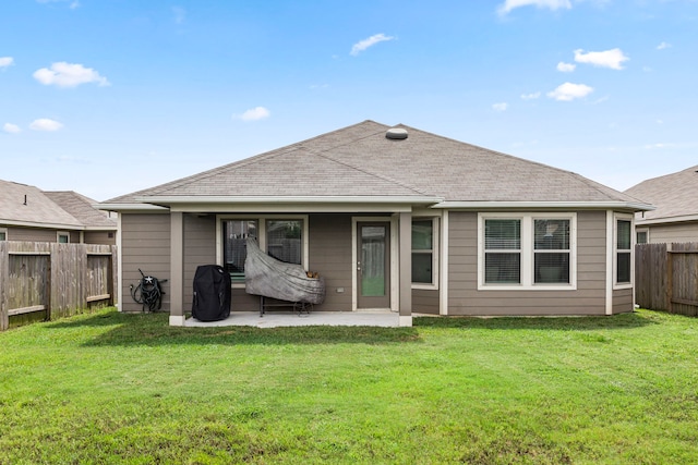 rear view of property with a lawn and a patio area