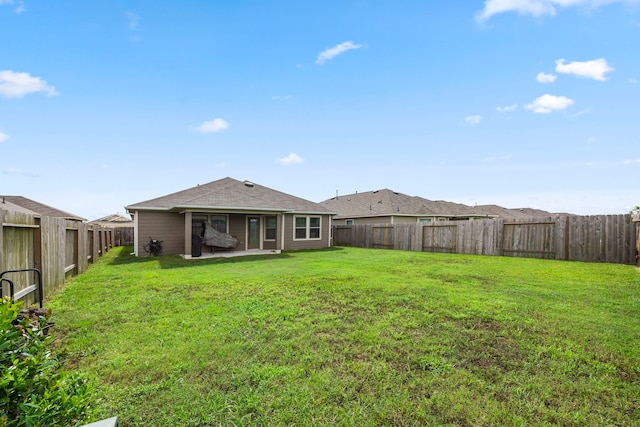 back of property featuring a patio area and a lawn