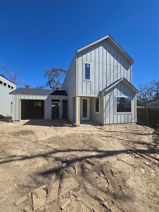 back of house featuring fence and board and batten siding