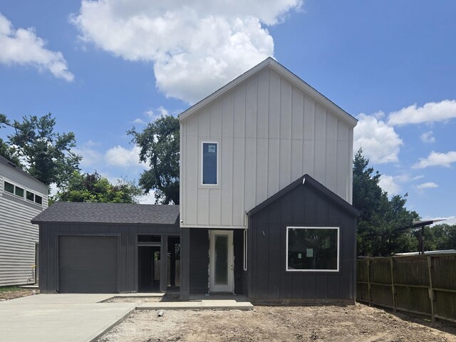 9630 Burden St, Houston, TX 77093 - view of front facade featuring board and batten siding, an attached garage, and driveway