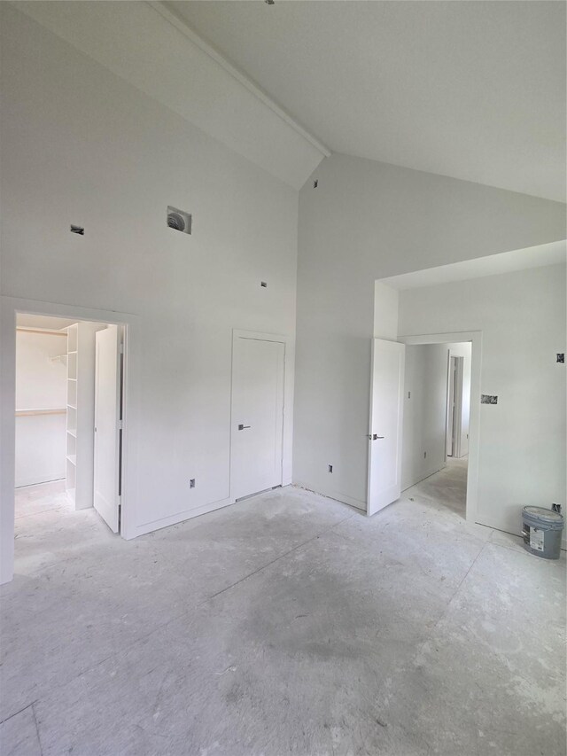 9630 Burden St, Houston, TX 77093 - unfurnished bedroom featuring high vaulted ceiling, a spacious closet, and concrete flooring