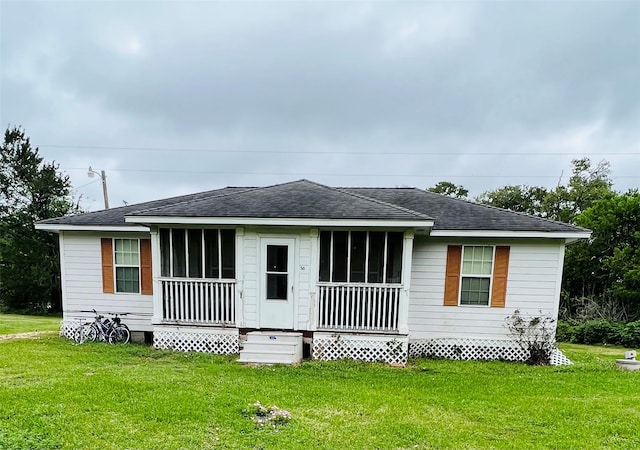 rear view of property with a yard