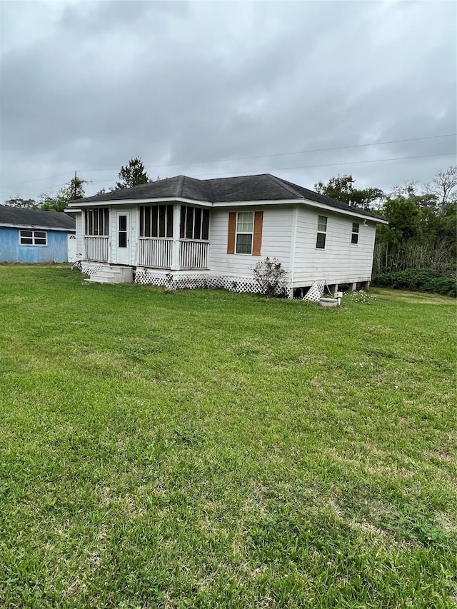 rear view of property featuring a yard and covered porch