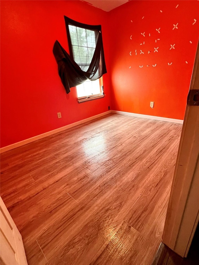 unfurnished room with hardwood / wood-style floors