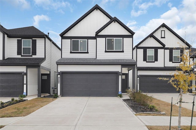 view of front of home with driveway, a shingled roof, board and batten siding, and an attached garage