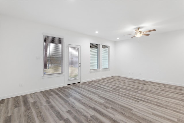 unfurnished room with ceiling fan and light hardwood / wood-style floors