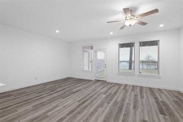 unfurnished living room featuring ceiling fan and light wood-type flooring