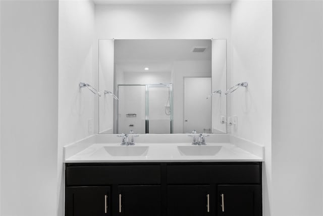 bathroom featuring vanity and an enclosed shower