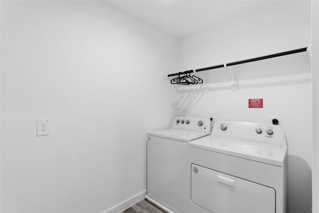 laundry room with hardwood / wood-style floors and washer and dryer