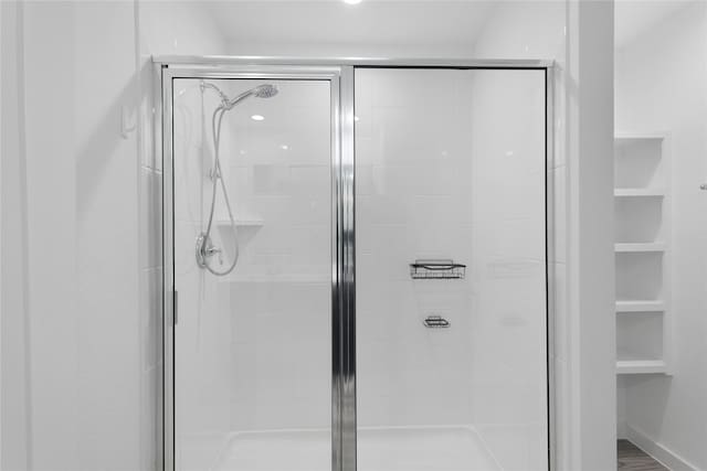 bathroom with a shower with door