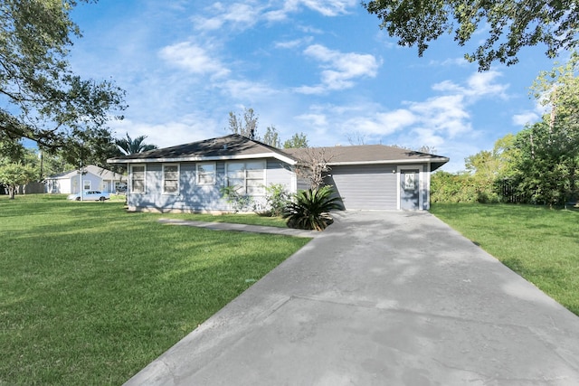 ranch-style house featuring a garage and a front yard