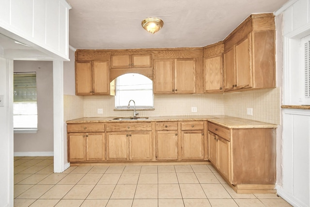 kitchen with sink, light tile patterned floors, and decorative backsplash