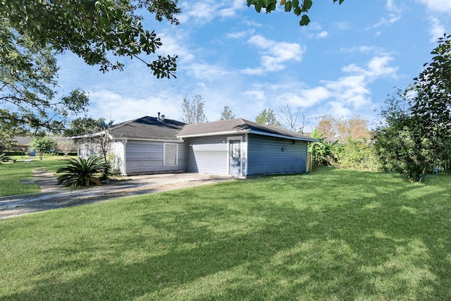 exterior space with a garage and a front lawn