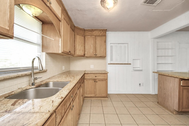 kitchen featuring sink and light tile patterned floors