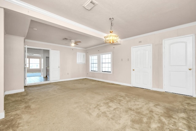 carpeted spare room featuring crown molding and ceiling fan