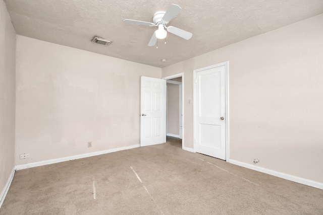 unfurnished bedroom with carpet floors, a textured ceiling, and ceiling fan