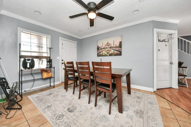 dining area featuring tile patterned flooring, ornamental molding, and ceiling fan