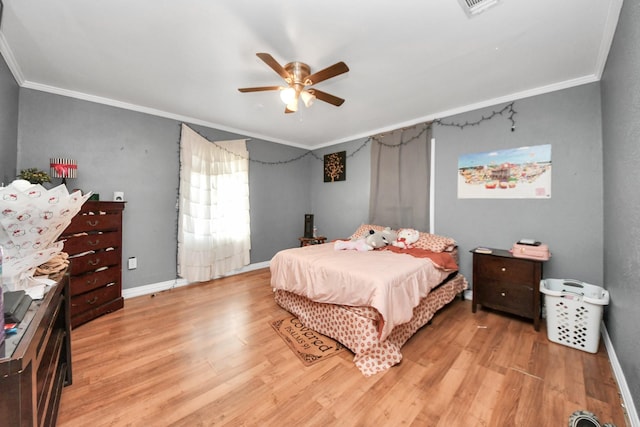 bedroom featuring ornamental molding, ceiling fan, and light hardwood / wood-style flooring