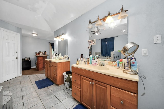 bathroom featuring lofted ceiling, vanity, and tile patterned flooring