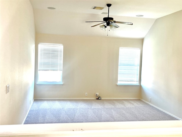 carpeted empty room with ceiling fan and lofted ceiling