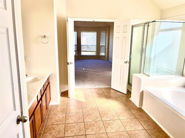 bathroom with vanity, plus walk in shower, and tile patterned flooring