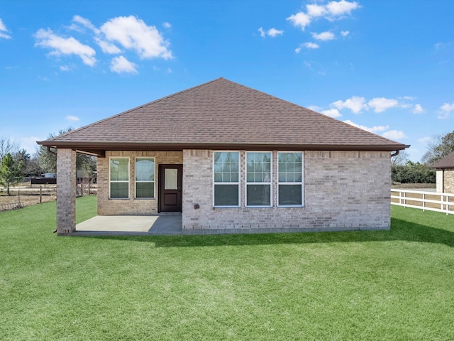 back of property featuring a patio and a yard