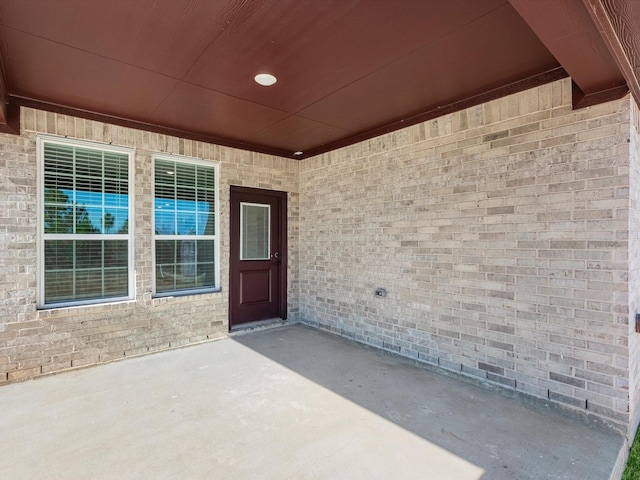 property entrance featuring a patio area