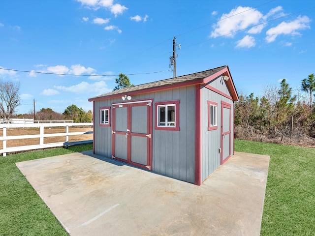 view of outbuilding featuring a lawn